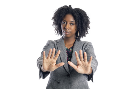 Black African American female businesswoman isolated on a white background doing a stop gestureの写真素材