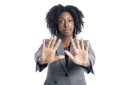 Black African American female businesswoman isolated on a white background doing a stop gestureの写真素材