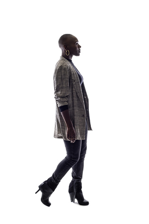 Black female African American model on a white background.  She is walking in side viewの写真素材