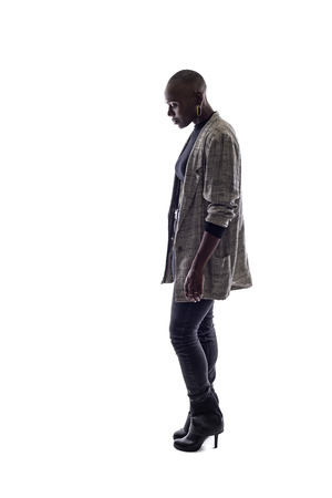 Black female African American model on a white background.  She is posed with a sad or depressed postureの写真素材