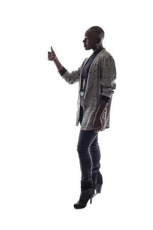 Black female African American model on a white background.  She is holding thumbs up in approvalの写真素材