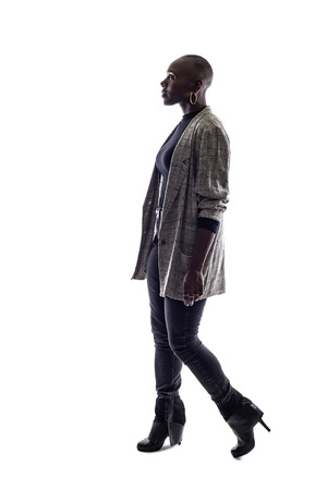 Black female African American model on a white background.  She is walking in side viewの写真素材
