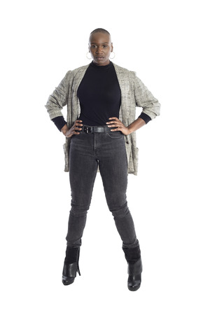 Black African American woman looking confident while wearing modern business casual outfit on a white background.  The businesswoman is depicting bold urban fashion style.の写真素材
