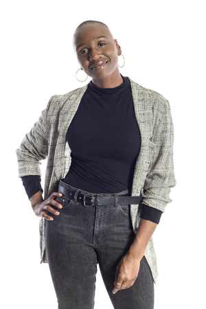Black African American woman looking confident while wearing modern business casual outfit on a white background.  The businesswoman is depicting bold urban fashion style.の写真素材