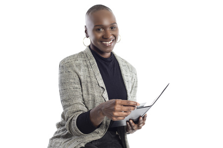 Black African American businesswoman posing with a bill or invoice.  She looks like a financial advisor or a consumer paying with a credit card.の写真素材