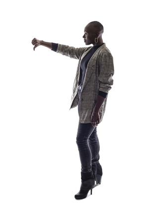 Black female African American model on a white background.  She is holding thumbs down in disapprovalの写真素材