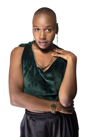 Beautiful black African American female model posing confidently with bald hairstyle on a white background.  The woman is portraying uniqueness and individuality.の写真素材