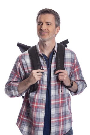 Middle-Aged man doing healthy activities during retirement by hiking or trekking or walking as a tourist when traveling.  He looks confident and happy carrying a backpack on a white background.の写真素材
