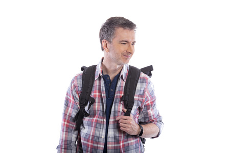 Middle-Aged man doing healthy activities during retirement by hiking or trekking or walking as a tourist when traveling.  He looks confident and happy carrying a backpack on a white background.の写真素材