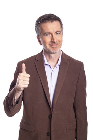 Middle aged bearded businessman on a white background wearing a brown jacket.  The mature man looks like a business executive with thumbs up.の写真素材