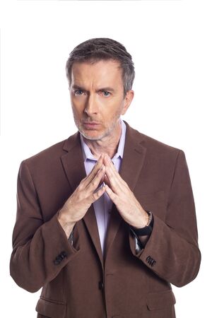 Middle aged bearded businessman on a white background wearing a brown jacket.  The mature man looks like a secretive or dishonest business executive.の写真素材
