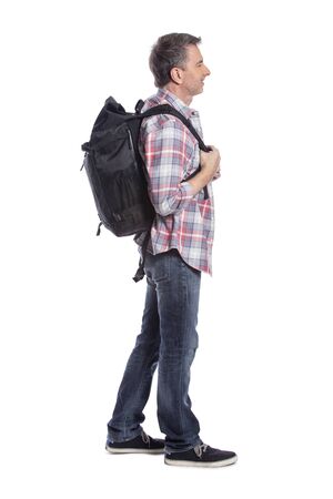 Middle-aged tour guide or hiker walking and pointing at something and isolated on a white background for composites.  He looks like he is trekking and depicts tourism and travel.の写真素材
