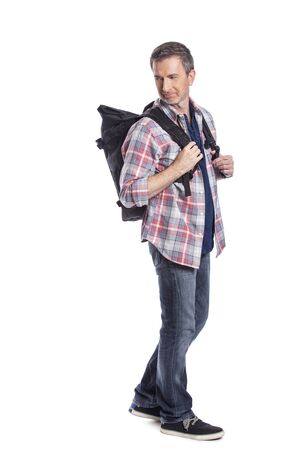 Middle-aged man hiking and carrying a backpack on a white background.  Depicts adventure and exploration.  Isolated for composites.の写真素材
