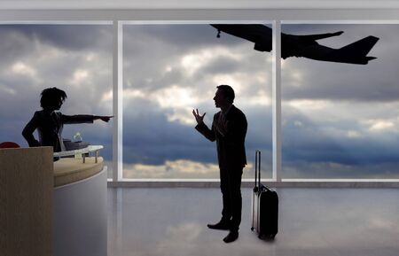Stressed out businessman passenger arguing with a flight attendant or receptionist at an airport check in counter.  He is angry because of a delayed or cancelled flight.の写真素材