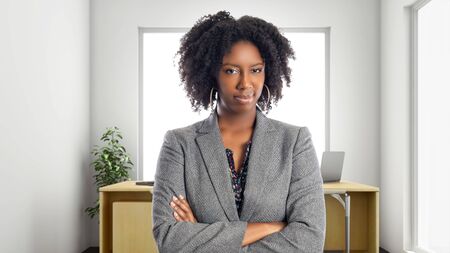 Black African American businesswoman in an office looking disgusted.  She is an owner or an executive of the workplace.  Depicts careers and startup business.の写真素材