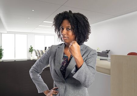 Black African American businesswoman in an office looking angry.  She is an owner or an executive of the workplace.  Depicts careers and startup business.の写真素材