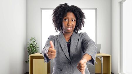 Black African American businesswoman in an office looking confused.  She is an owner or an executive of the workplace.  Depicts careers and startup business.の写真素材