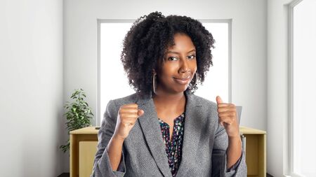 Black African American businesswoman in an office looking angry.  She is an owner or an executive of the workplace.  Depicts careers and startup business.の写真素材
