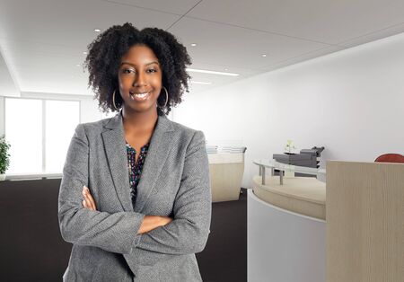Black African American businesswoman in an office looking confident or arrogant.  She is an owner or an executive of the workplace.  Depicts careers and startup business.の写真素材
