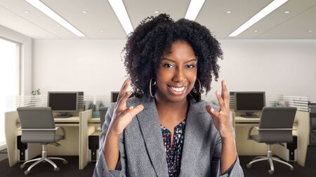 Black African American businesswoman in an office looking angry.  She is an owner or an executive of the workplace.  Depicts careers and startup business.の写真素材