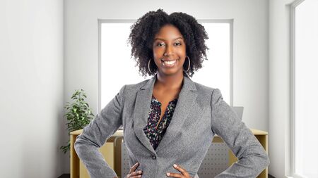 Black African American businesswoman in an office looking confident or arrogant.  She is an owner or an executive of the workplace.  Depicts careers and startup business.の写真素材