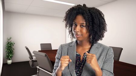 Black African American businesswoman in an office looking angry.  She is an owner or an executive of the workplace.  Depicts careers and startup business.の写真素材