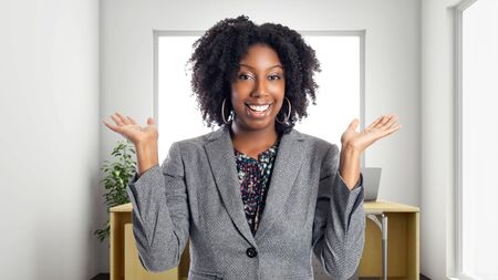 Black African American businesswoman in an office looking surprised.  She is an owner or an executive of the workplace.  Depicts careers and startup business.の写真素材