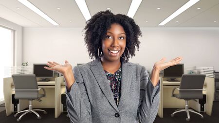 Black African American businesswoman in an office looking surprised.  She is an owner or an executive of the workplace.  Depicts careers and startup business.の写真素材