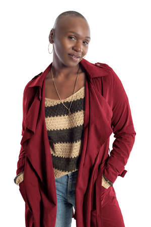 Black African American fashion model with bald hairstyle confidently posing with a coffee brown colored jacket for fall collection.  Depicts fashion design and clothing apparelの写真素材