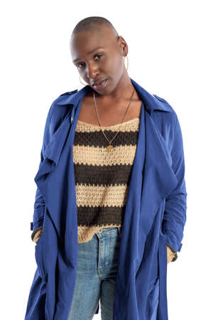 Black African American fashion model with bald hairstyle confidently posing with a coffee brown colored jacket for fall collection.  Depicts fashion design and clothing apparelの写真素材