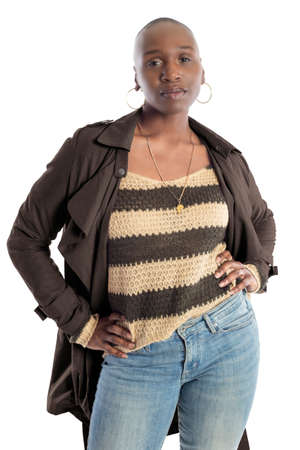 Black African American fashion model with bald hairstyle confidently posing with a coffee brown colored jacket for fall collection.  Depicts fashion design and clothing apparelの写真素材