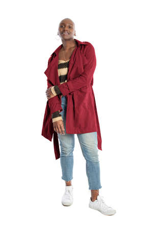 Black African American fashion model with bald hairstyle confidently posing with a coffee brown colored jacket for fall collection.  Depicts fashion design and clothing apparelの写真素材