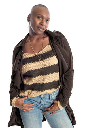 Black African American fashion model with bald hairstyle confidently posing with a coffee brown colored jacket for fall collection.  Depicts fashion design and clothing apparelの写真素材