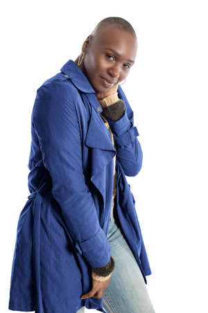 Black African American fashion model with bald hairstyle confidently posing with a red colored jacket for fall collection.  Depicts fashion design and clothing apparelの写真素材