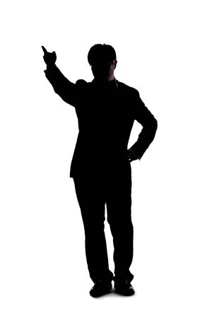 Full body silhouette of a businessman isolated on a white background. He is pointing at copy or text space like he is advertising or promoting something.の写真素材