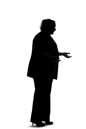 Silhouette of a curvy or plus size businesswoman on a white background.  She is posed like she is talking to someone. の写真素材