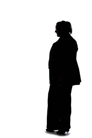 Silhouette of a curvy or plus size businesswoman on a white background.  She is posed like she is bored of waiting and standing.の写真素材