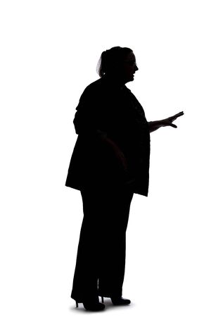 Silhouette of a curvy or plus size businesswoman on a white background.  She is posed like she is talking to someone.の写真素材