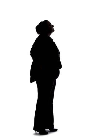 Silhouette of a curvy or plus size businesswoman on a white background.  She is posed like she is bored of waiting and standing.の写真素材