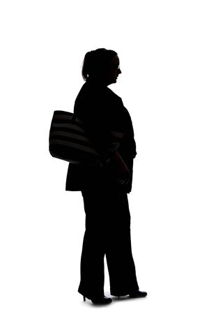 Silhouette of a curvy or plus size businesswoman on a white background.  She is posed like she is walking in side view.の写真素材