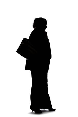 Silhouette of a curvy or plus size businesswoman on a white background.  She is posed like she is bored of waiting and standing.の写真素材