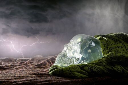 Scary or creepy glowing crystal skull on Halloween holiday or Dia De Los Muertos Day of the Dead festival.  Depicts horror theme and superstition.の写真素材