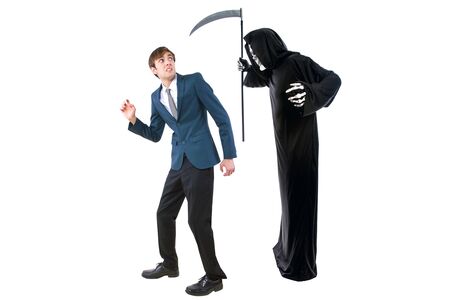 Man in a Halloween grim reaper ghost costume chasing, mocking and making fun of scared businessman running away.  Can also depict death following a man as a metaphor for life insurance.の写真素材