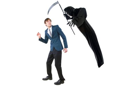 Man in a Halloween grim reaper ghost costume chasing, mocking and making fun of scared businessman running away.  Can also depict death following a man as a metaphor for life insurance.の写真素材