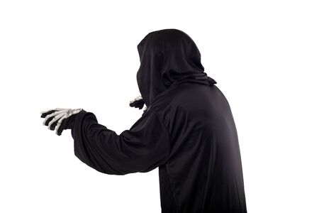 The grim reaper or death halloween costume isolated on a white background.  The skeleton is wearing a hooded black robe. Side view in profile for composites.の写真素材