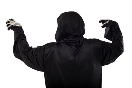 The grim reaper or death halloween costume isolated on a white background.  The skeleton is wearing a hooded black robe. Side view in profile for composites.の写真素材