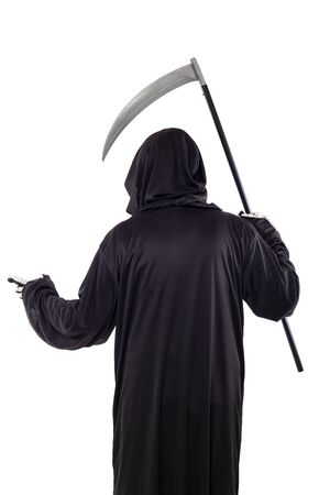 The grim reaper or death halloween costume isolated on a white background.  The skeleton is wearing a hooded black robe. Side view in profile for composites.の写真素材