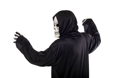 The grim reaper or death halloween costume isolated on a white background.  The skeleton is wearing a hooded black robe. Side view in profile for composites.の写真素材