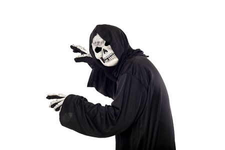 The grim reaper or death halloween costume isolated on a white background.  The skeleton is wearing a hooded black robe. Side view in profile for composites.の写真素材