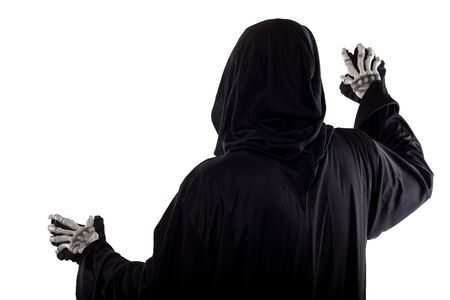 The grim reaper or death halloween costume isolated on a white background.  The skeleton is wearing a hooded black robe. Side view in profile for composites.の写真素材